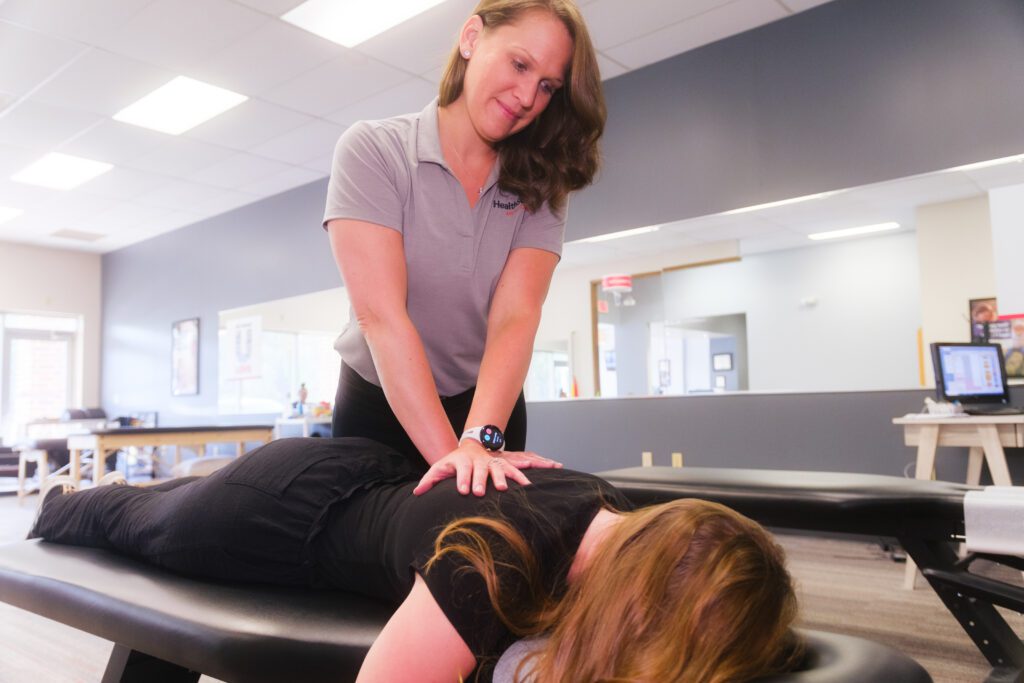 A patient receiving a chiropractic adjustment, showcasing opportunities in health and wellness franchise businesses.