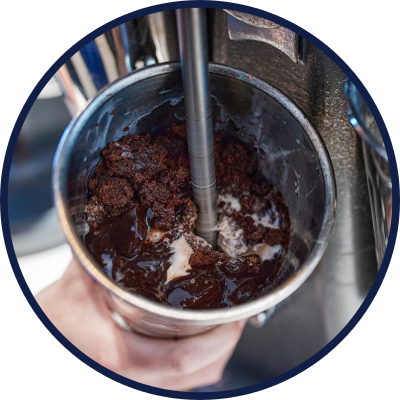 A milkshake being prepare with ingredients in a blender, showcasing the process of creating a delicious treat. 