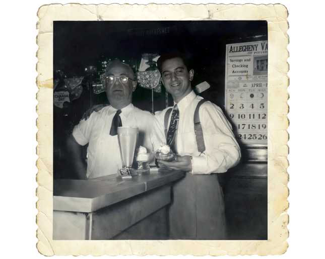 Black and white photo of the founders of a milkshake factory, reflecting the origins and history of the franchise.