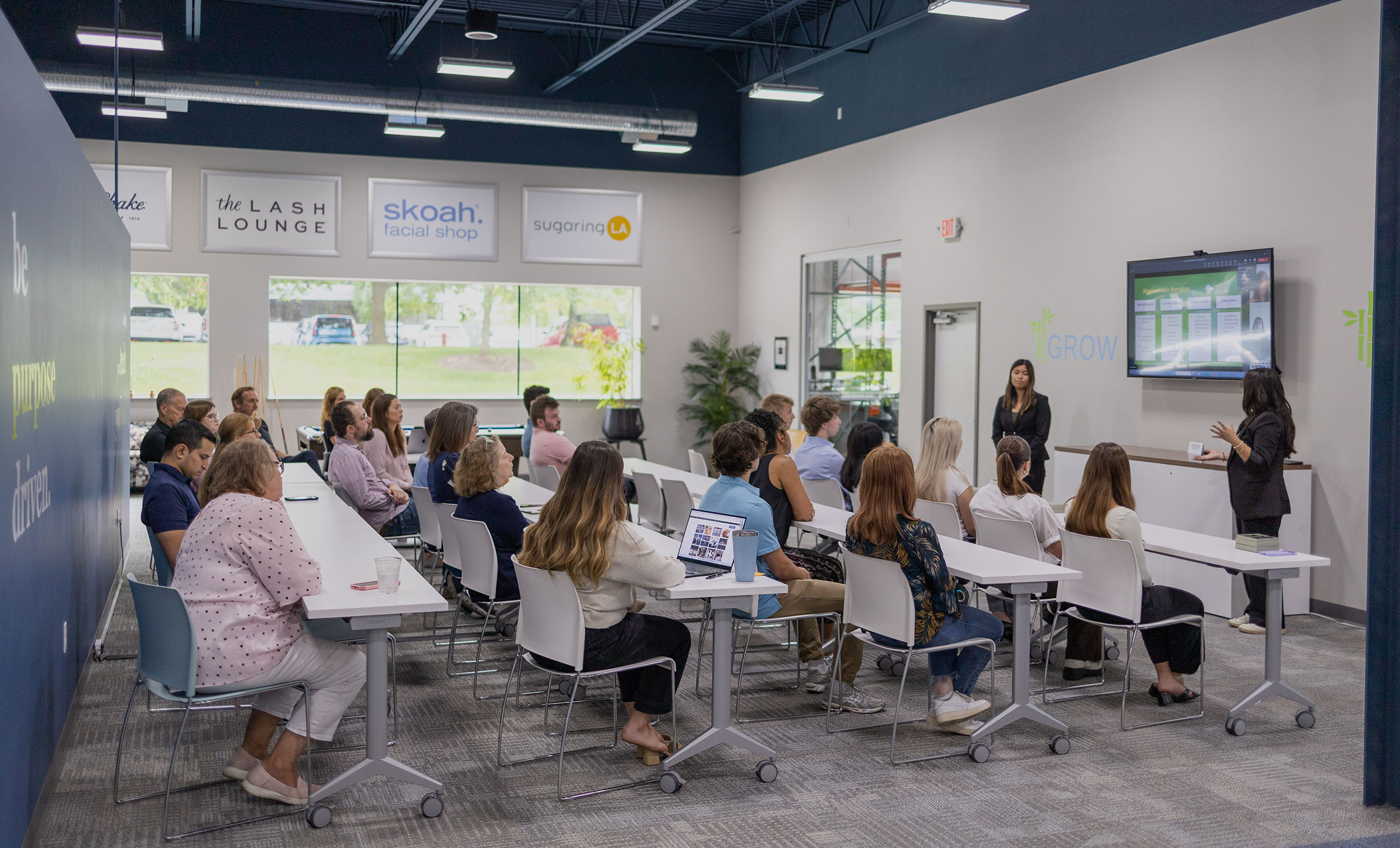 A group of people discussing how to franchise a business at tables in a room.