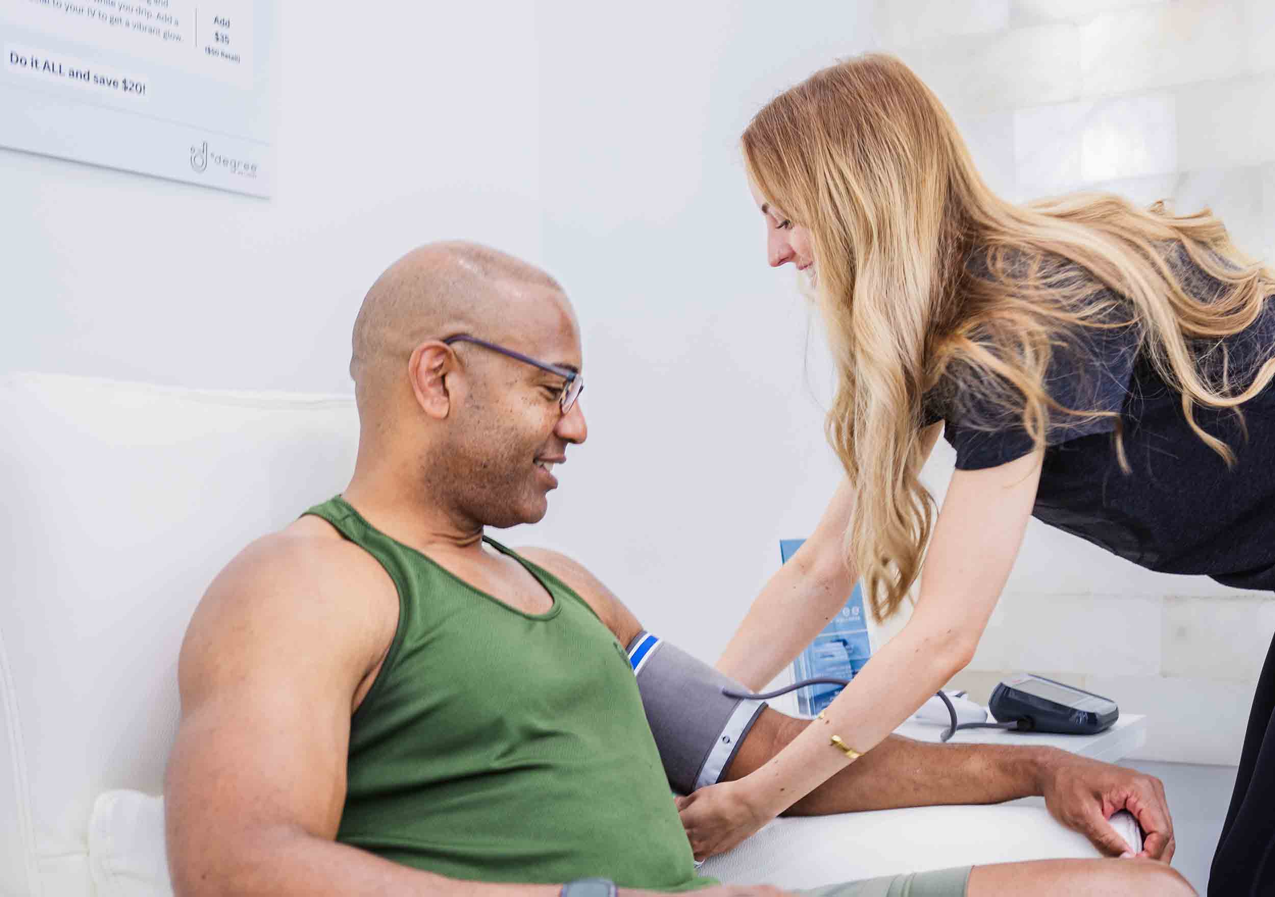 A client receiving an IV vitamin drip at a wellness center, a key offering of an IV therapy franchise.