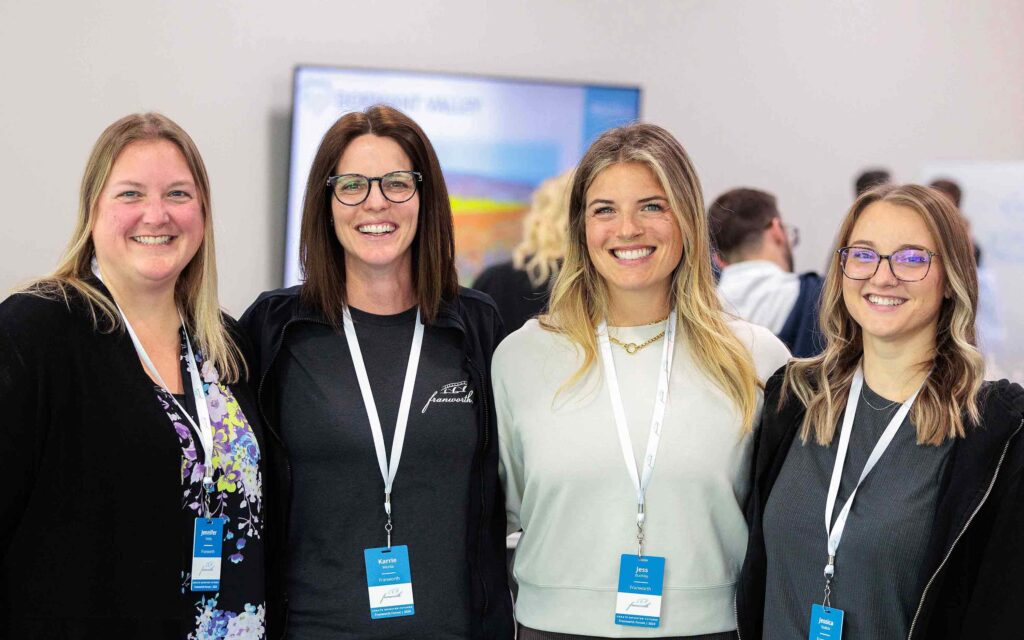 Four coworkers pose for a photo.